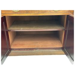 Victorian walnut clerk's desk, raised central section with tambour roll over hinged top, the interior fitted with leather inset writing surfaces, small drawers, document divisions and pen and ink stand, central drawer over double panelled cupboard, flanked by two banks of four graduating drawers, on bracket feet 