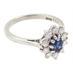 18ct white gold oval cut sapphire and round brilliant cut diamond cluster ring, London 1973, sapphire approx 0.50 carat, total diamond weight approx 0.30 carat 