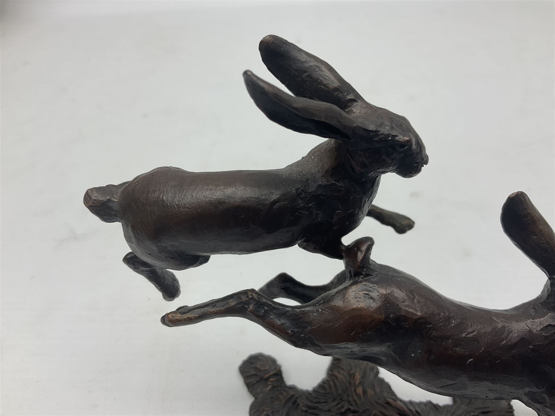 Michael Simpson: bronze Small Hares Running, modelled as three hares, limited edition 29/350, with certificate, H11cm 