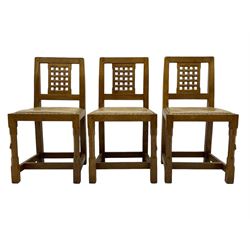 Rabbitman - set of six (5+1) oak dining chairs, pierced and carved lattice back, leather upholstered seat with stud band, on octagonal supports united by stretchers, carved with rabbit signature, by Peter Heap of Wetwang 