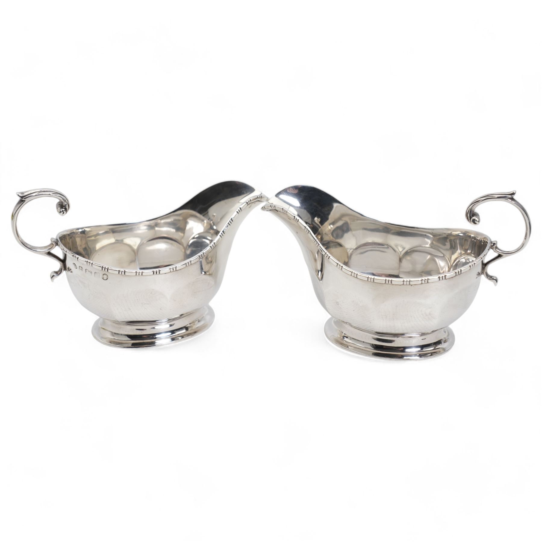 Pair of silver panel sided sauce boats with leaf capped C scroll handles Birmingham 1935 Maker Adie Brothers