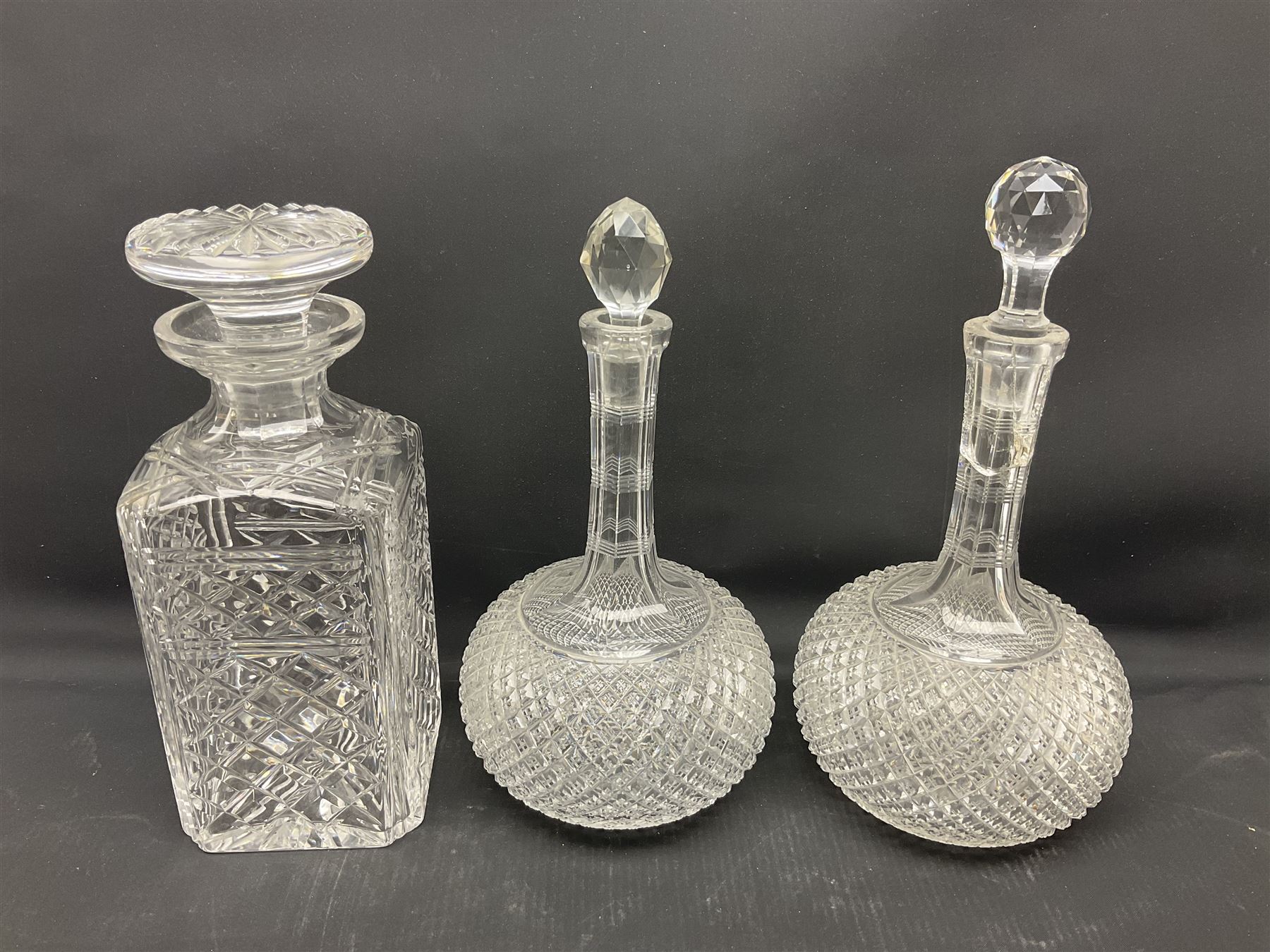 Collection of 18th century and later cut glass, including a pair of Victorian onion shaped decanters with elongated necks and hobnail cut decoration, together with a similar jug, of tapering form with C handle and an Georgian cut glass jug, with stepped decoration to neck and square cut decoration to body, tallest jug H30cm