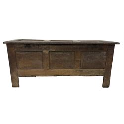 18th century oak coffer or chest, rectangular hinged panelled top with moulded frame enclosing candle box, the frieze carved with foliate S-scrolls over a quadruple panel front decorated with carved lozenges, on stile supports