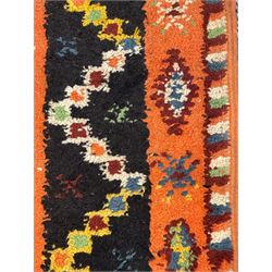 Moroccan amber ground thick pile rug, the field decorated with stylised geometric lozenges and camel motifs, the guard bands with stylised foliate and plant motifs