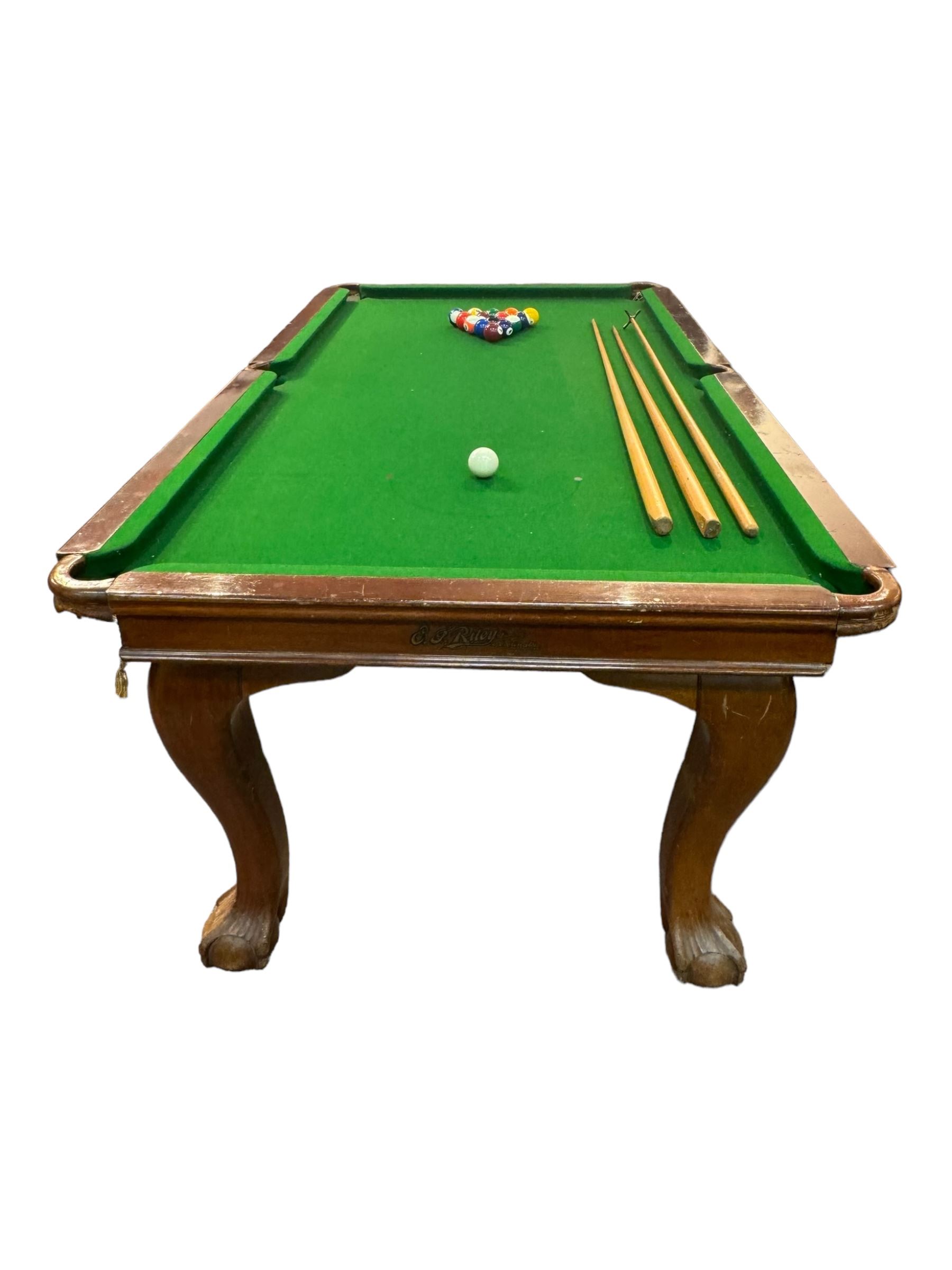 Riley - mahogany slate bed snooker dining table, green baize playing surface fitted with leather net pockets, raised on cabriole supports ending in ball and claw feet; together with set of Riley cues, balls and scoreboard