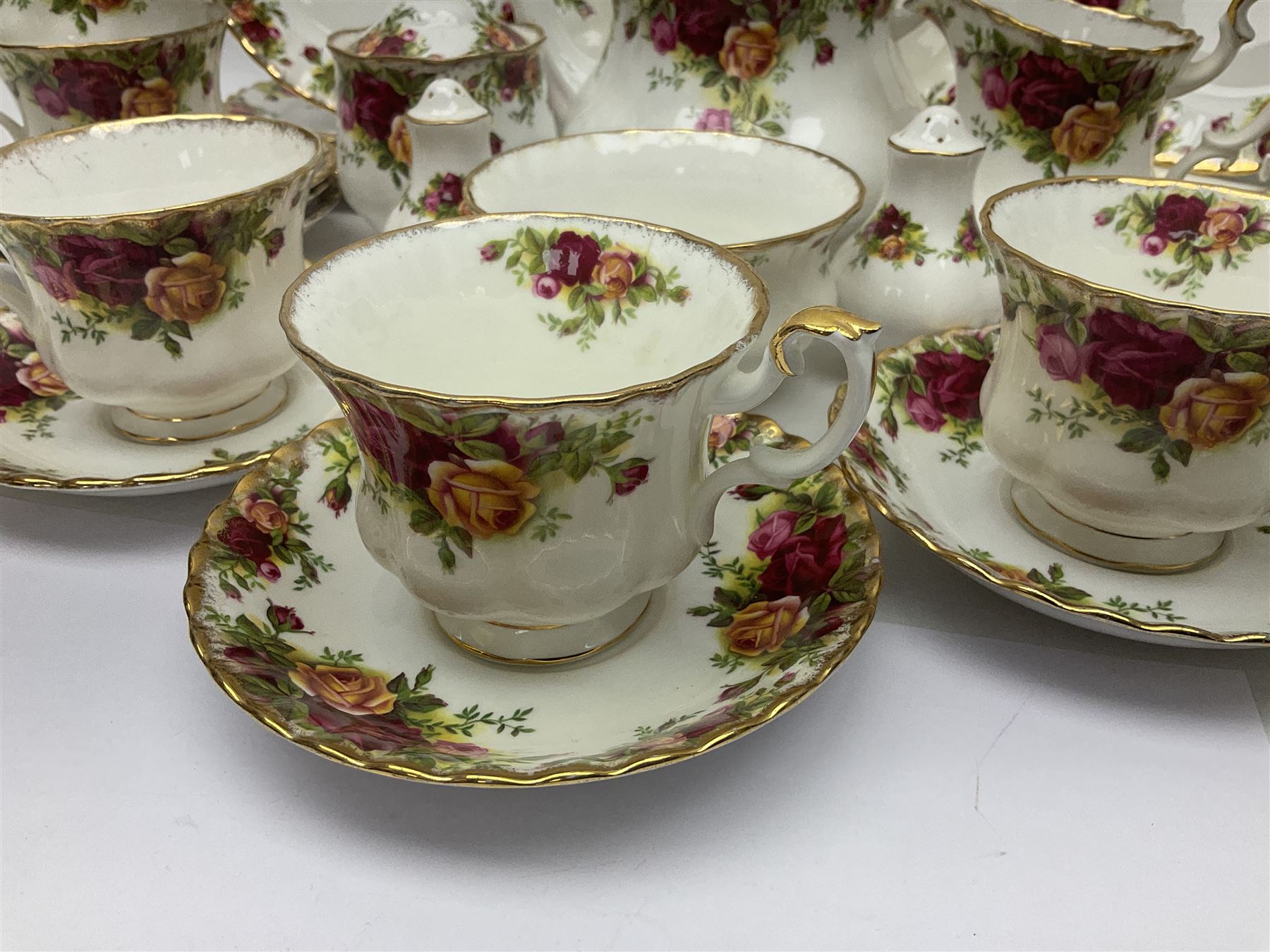 Royal Albert Old Country Roses tea service, comprising teapot, milk jug, covered sucrier, open sucrier, salt and pepper, twelve dessert plates, cake plate, seven cups and eight saucers  