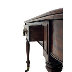 George III mahogany extending dining table, reed moulded rectangular top with rounded corners, two D-ends each fitted with two drawers, two additional leaves, on turned supports with ribbed brass cups and castors 