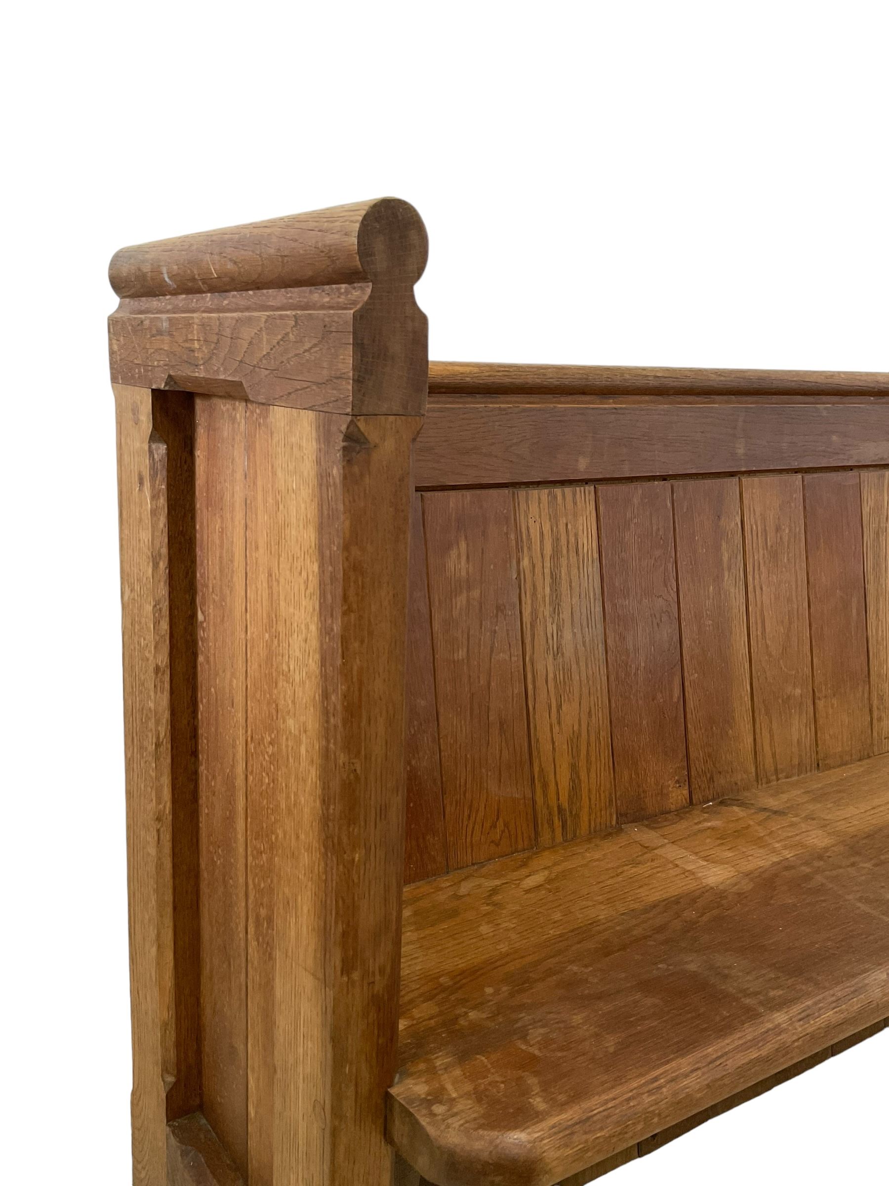 19th century oak church pew or hall bench, moulded cresting rail over panelled back and plank seat, on panelled end supports with chamfered frames