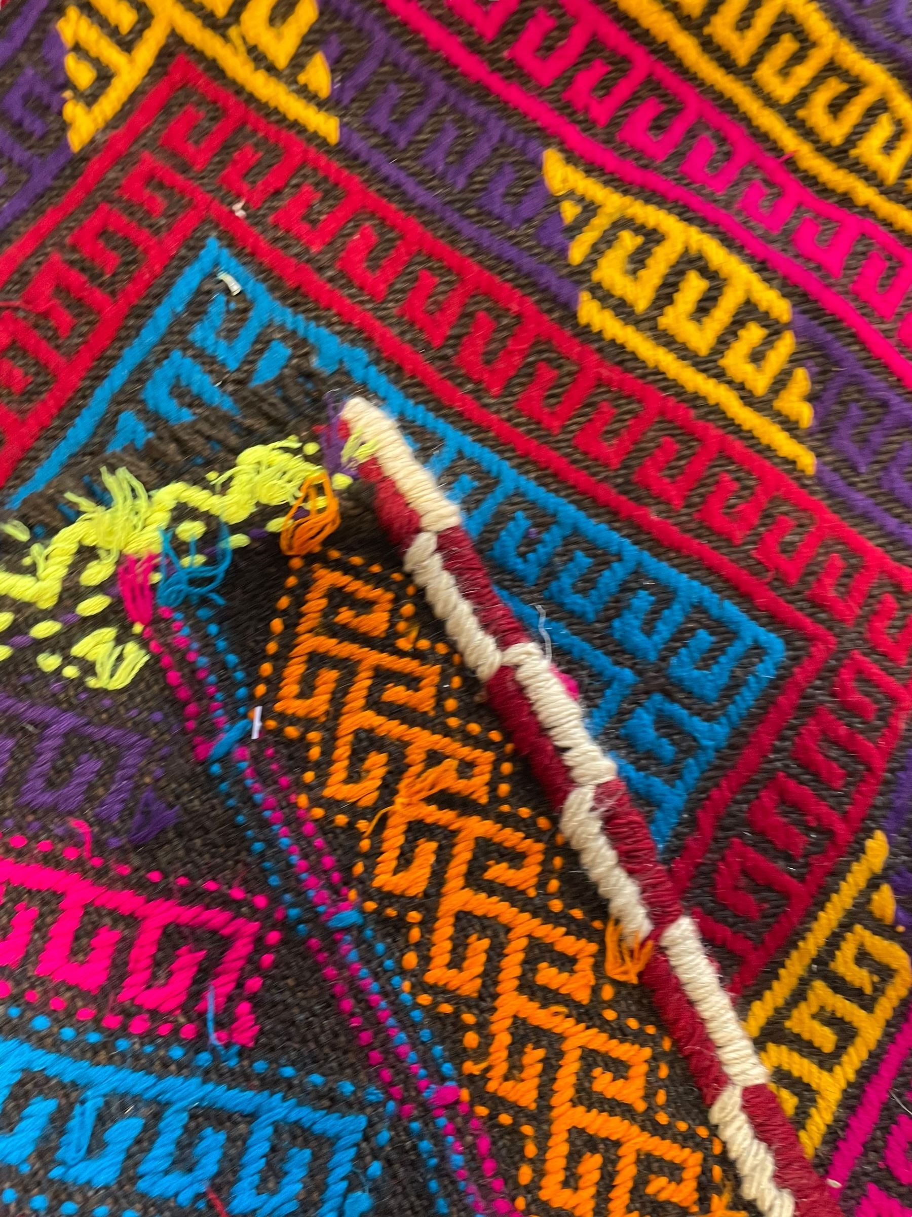 Flatweave geometric design runner rug, decorated with trailing lozenges decorated with hooked motifs, within zig-zag bands, bright multi-coloured ground 