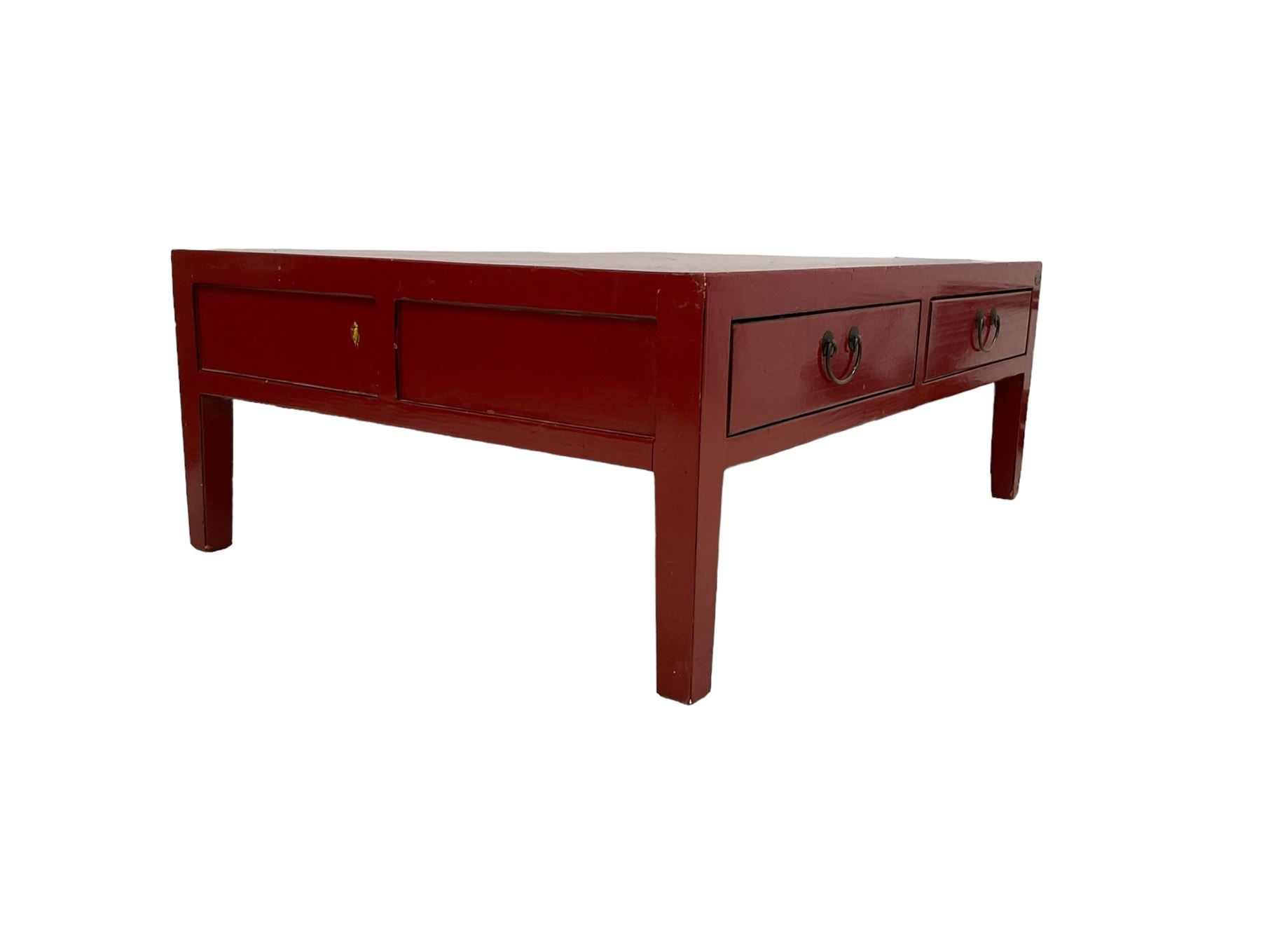 Chinese design red lacquered coffee table, rectangular form on square tapering supports, fitted with two drawers 