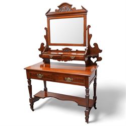 Late Victorian walnut dressing table, raised swing mirror back over two trinket drawers with brass Art Nouveau handle plates, rectangular top fitted with two further drawers, raised on square ring-turned supports united by shaped under-tier, on castors