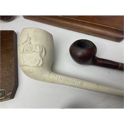 Collection of smoking pipes including Meerschaum pipe, carved as a female head, Briars and clay examples, etc and four pipe racks/stands