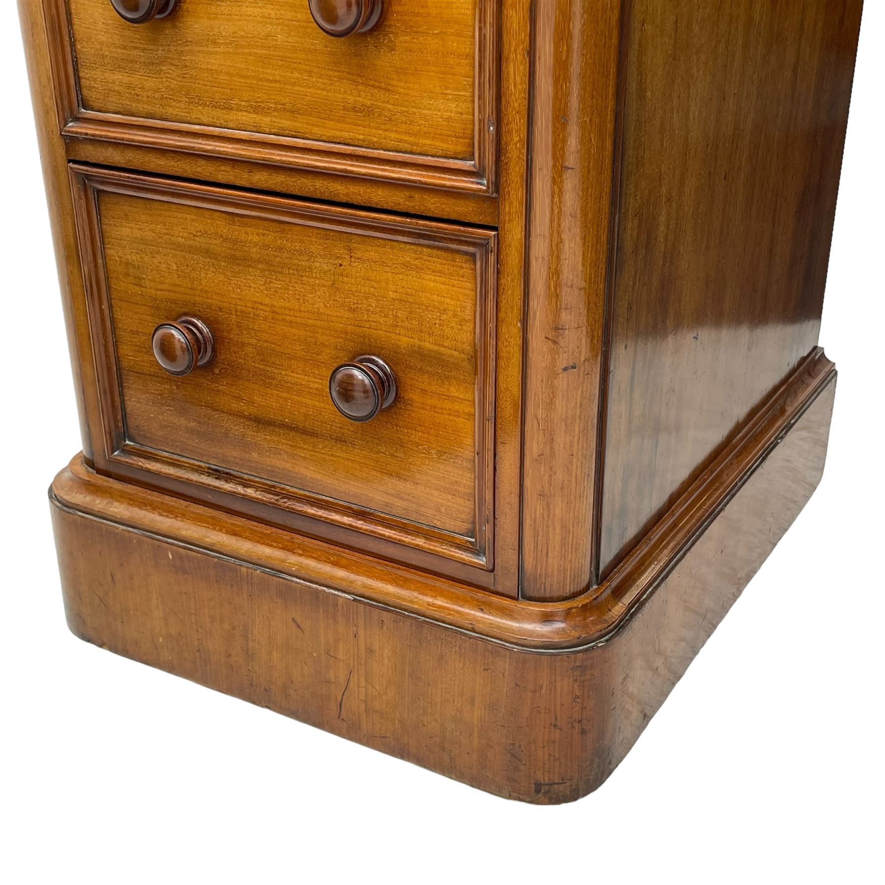 Pair of Victorian figured mahogany pedestal chests, rectangular form with rounded front corners, moulded top over three drawers with applied mouldings and turned handles, on moulded plinth base