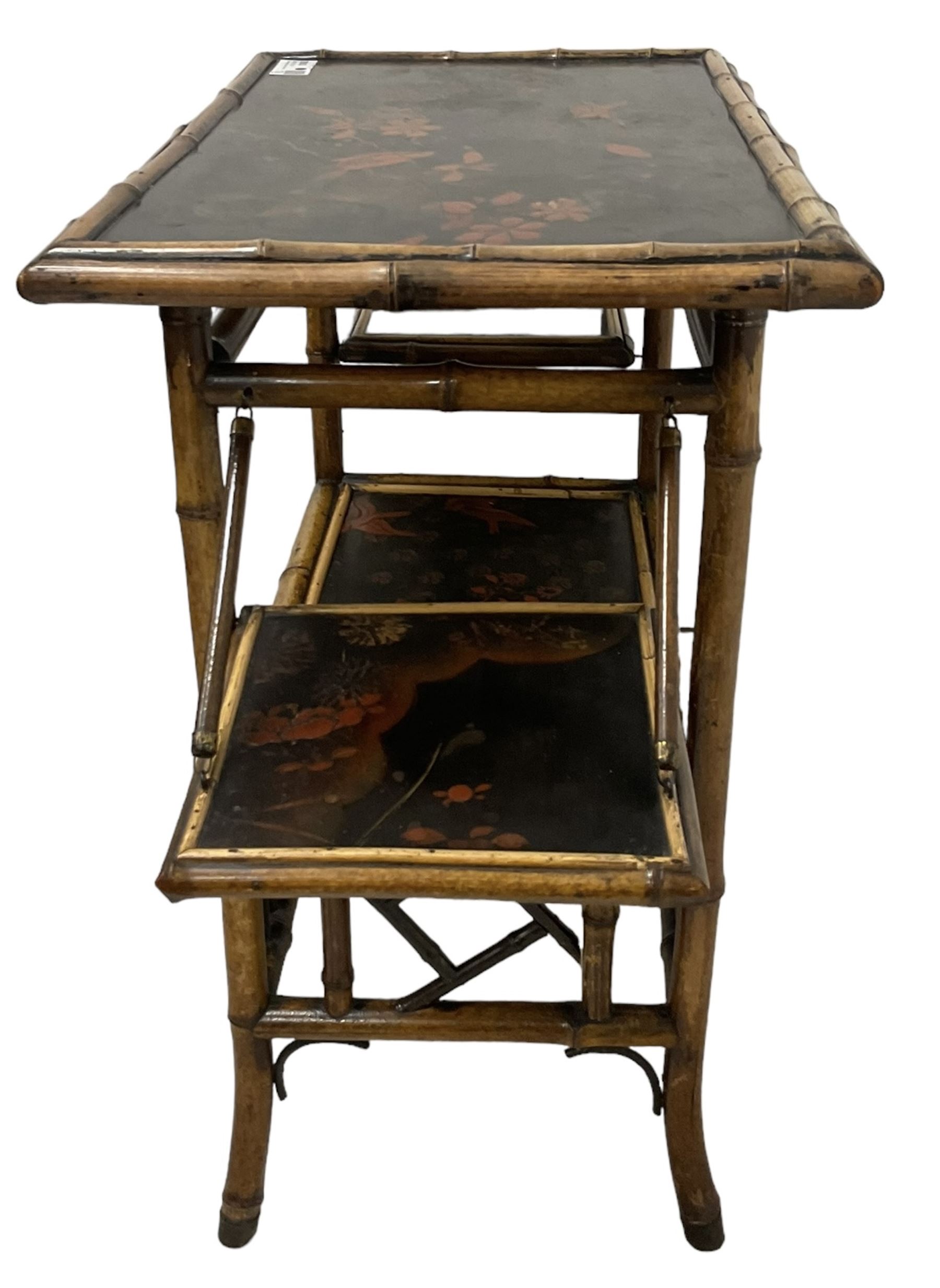 Late 19th century Aesthetic Movement lacquered and painted bamboo occasional table, rectangular top painted with Japanned traditional bird and blossom scenes, over two fold-out side leaves and undertier with pierced gallery apron