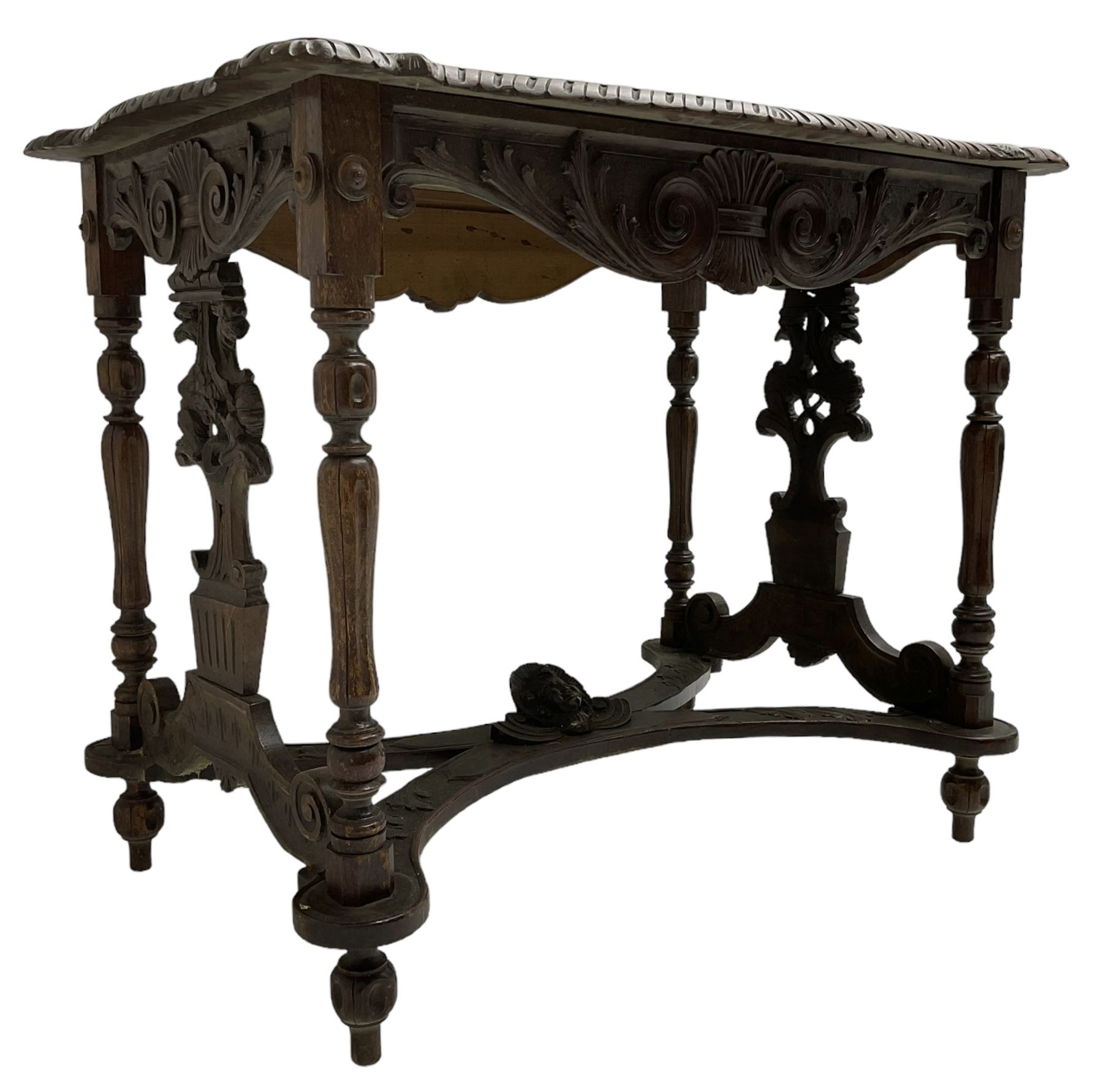 19th century walnut centre table, shaped top carved with central cartouche and extending scrolled foliage, the shaped frieze rails carved with scrolling acanthus leaves, turned supports with central end supports carved with flower heads and scrolls, curved x-framed stretcher carved with a central mask depicting a girl in a bonnet, on turned and carved feet