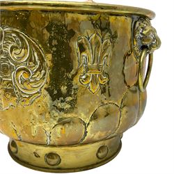 Early 20th century cylindrical brass coal or log bin, embossed with crest and fleur-de-lis motifs, gadrooned underbelly 