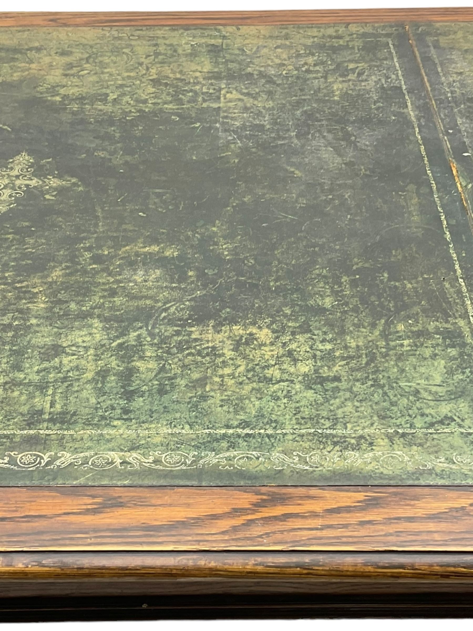 Large 10' 7'' late Victorian oak boardroom table, moulded rectangular top with inset green leather surface, on turned and reed moulded supports with brass and ceramic castors 