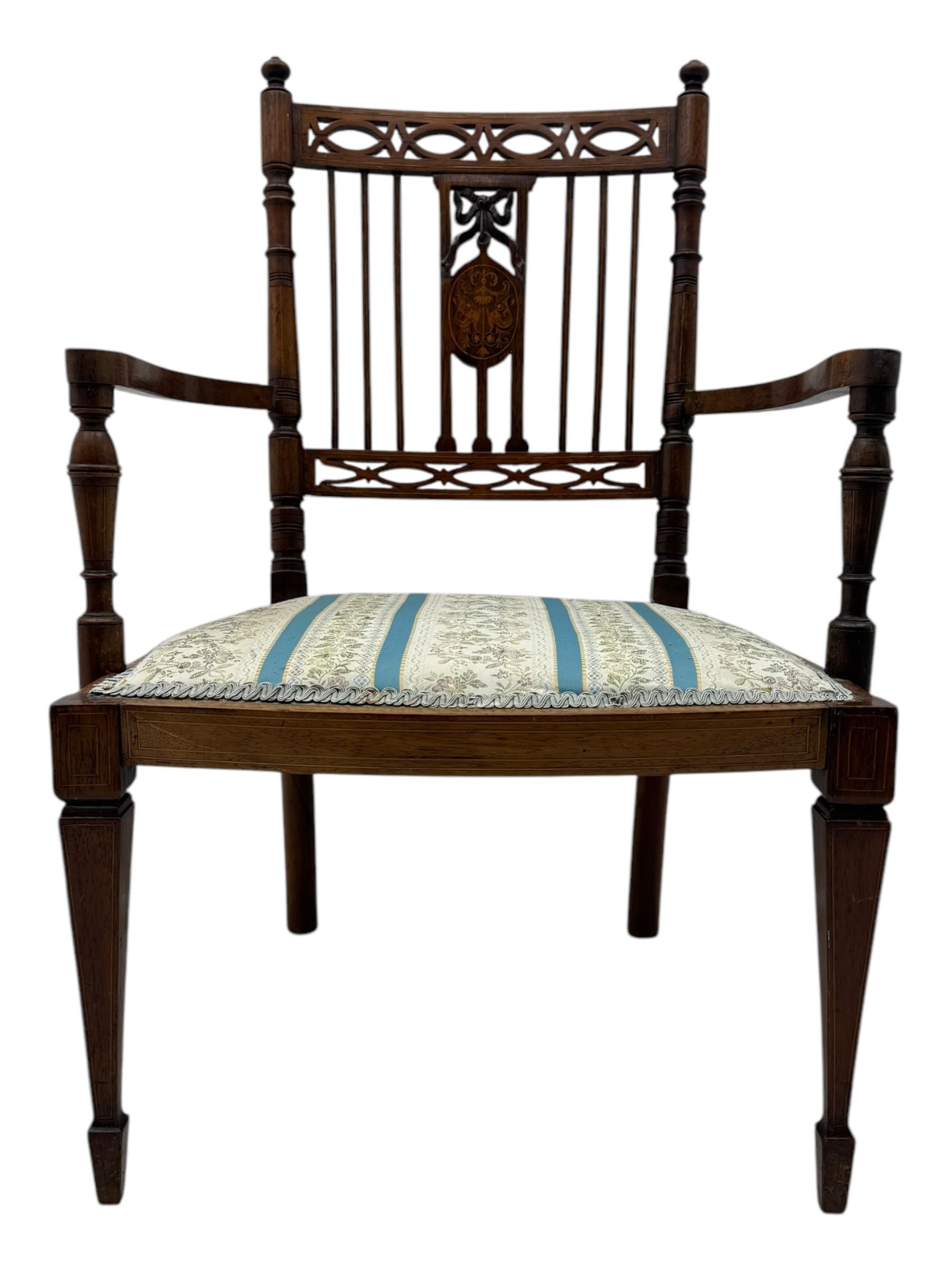 Edwardian inlaid rosewood elbow chair, pierced cresting rail over carved ribbon tie and oval inlaid panel, upholstered in stripe and floral pattern fabric, on square tapering supports with spade feet 