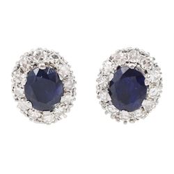 Pair of palladium and gold oval sapphire and single cut diamond cluster stud earrings, tot...