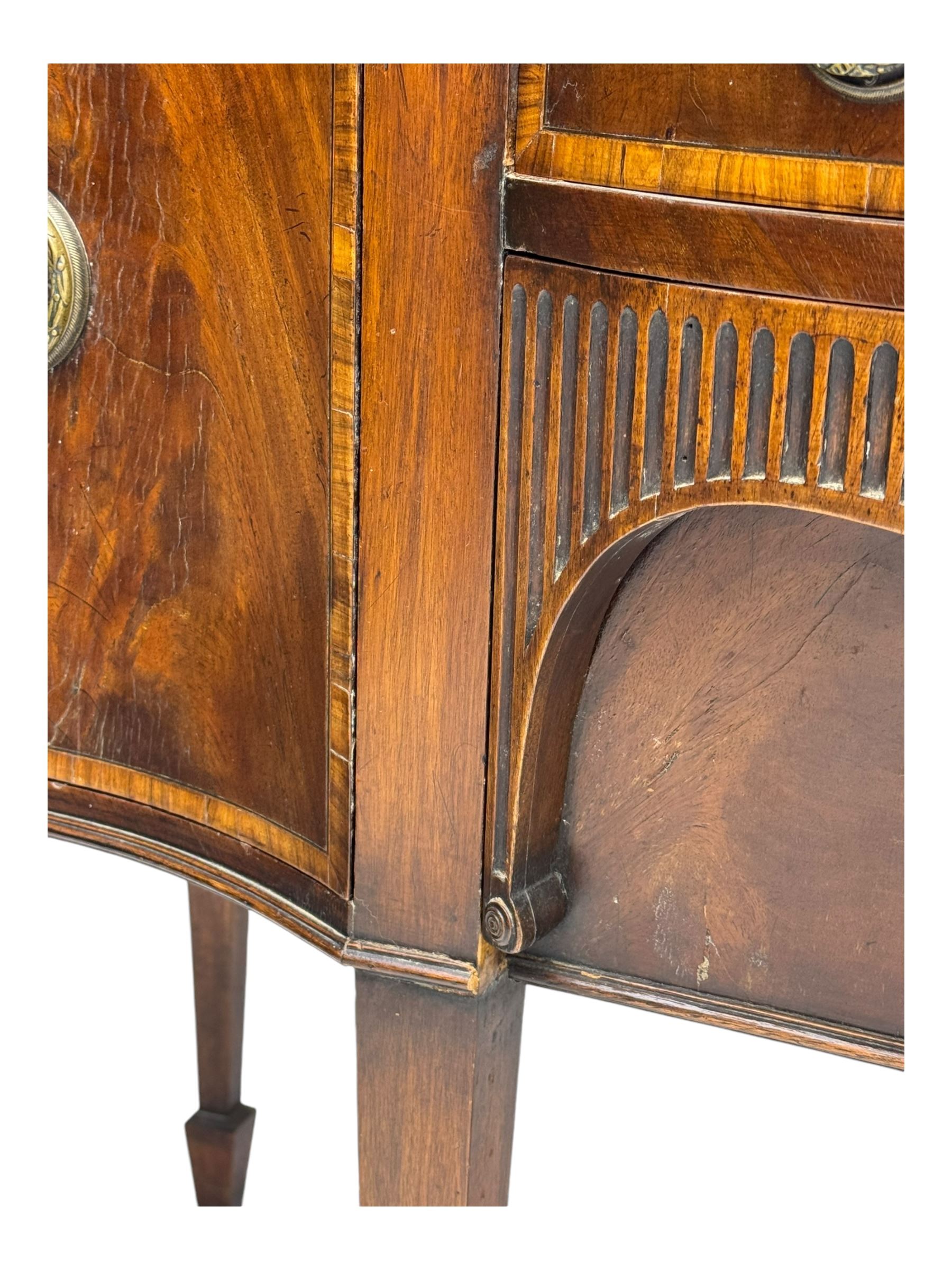 Early 19th century serpentine sideboard, fitted with two cupboards and two drawers, on square tapering supports with spade feet