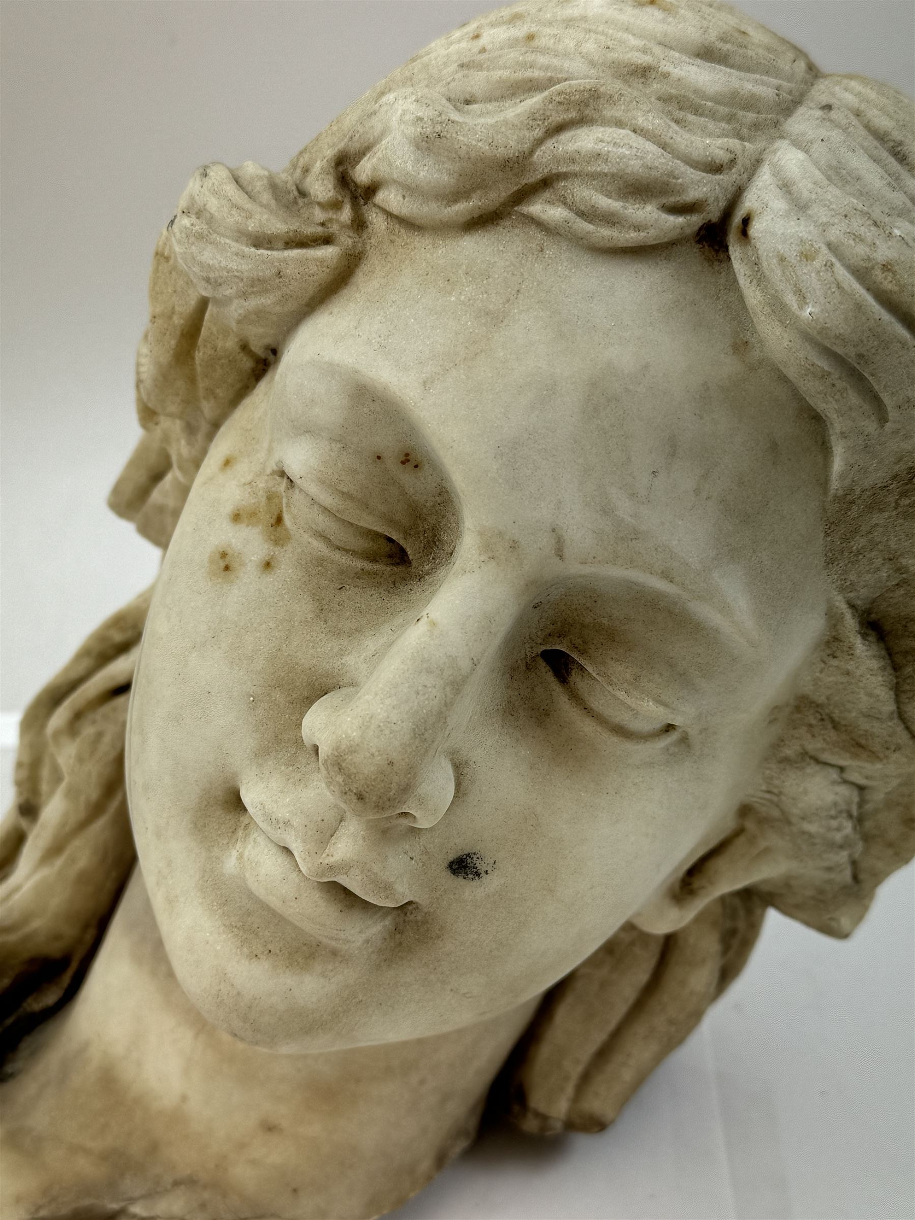 Fragmentary white marble head of a female bust, H31cm