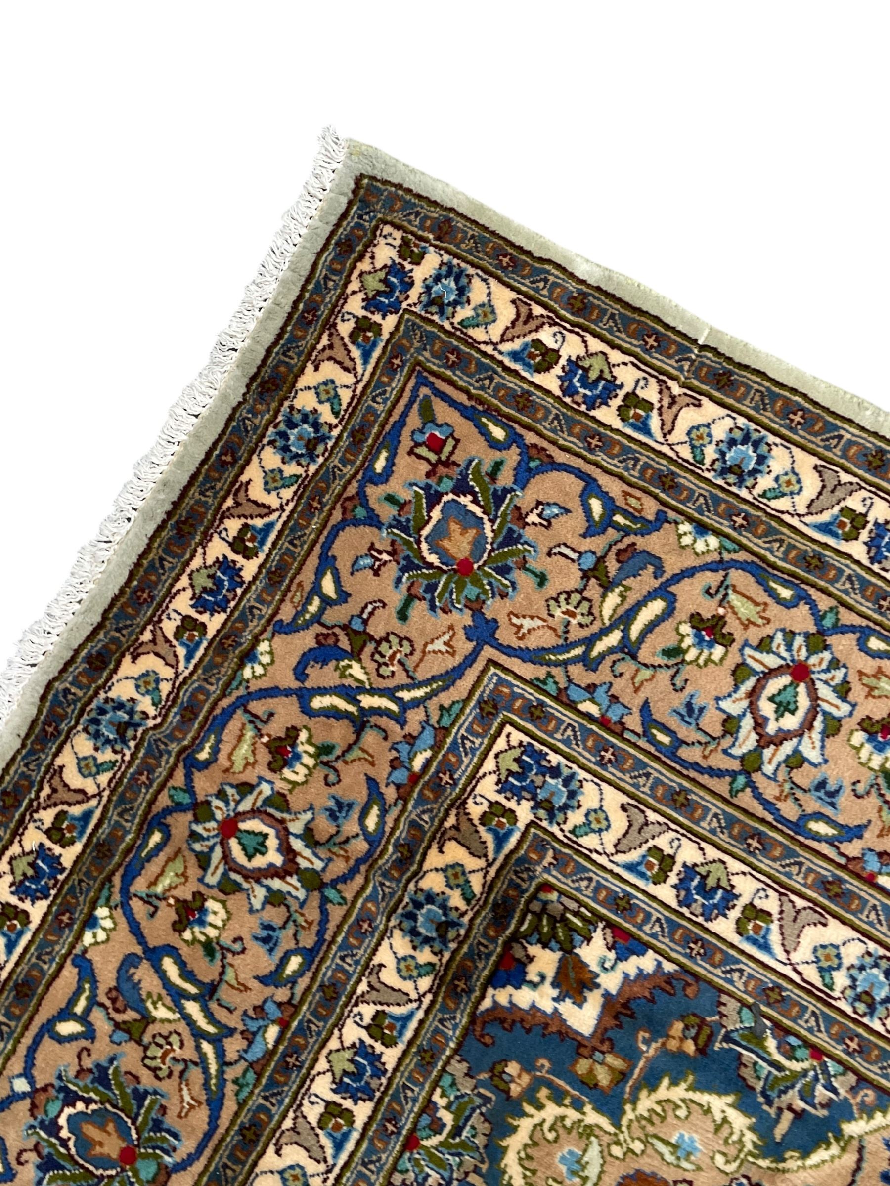 Persian Kashmar pale green ground rug, shaped central medallion decorated with stylised flower heads, the surrounding field with scrolling leafy branches and palmettes, the spandrels and border decorated with further palettes, within floral pattern guard stripes