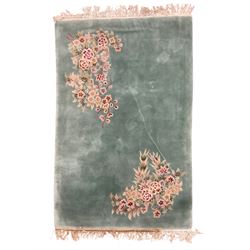 Chinese pale turquoise ground washed woolen rug, the plain field decorated with two large floral bouquet motifs with extending blossom and leafage