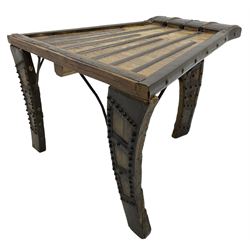 19th century Indian bullock / ox cart converted coffee table, trapezoidal top with applied metal decoration and iron stretchers, raised on three swept supports with stud decoration