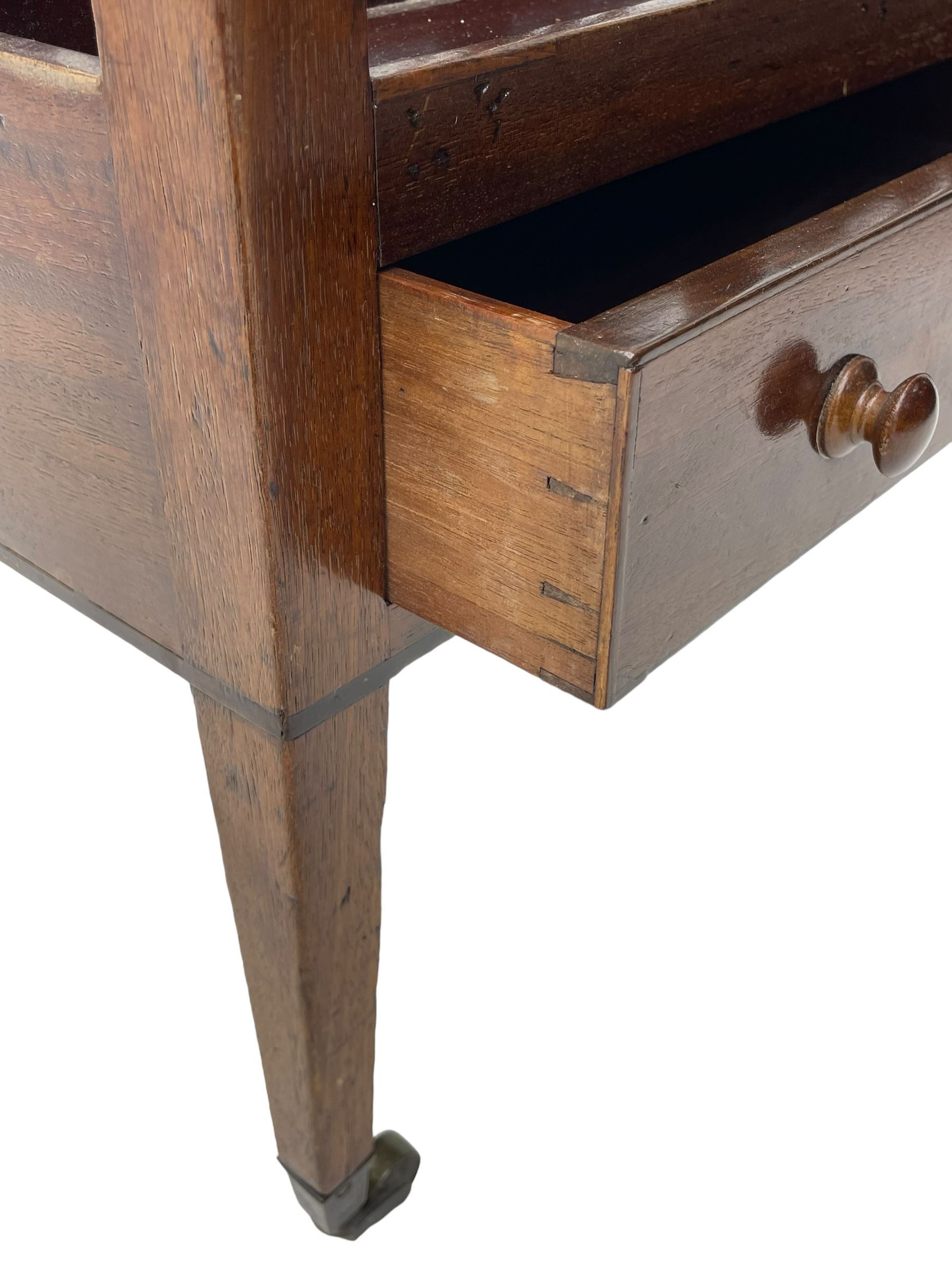 George III mahogany Canterbury, four divisions, fitted with single drawer with turned handles, on square tapering supports with brass cups and castors 