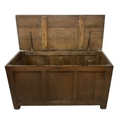 Large 18th century oak coffer or blanket box, hinged lid over triple panelled front, panelled back and sides, on stile supports 