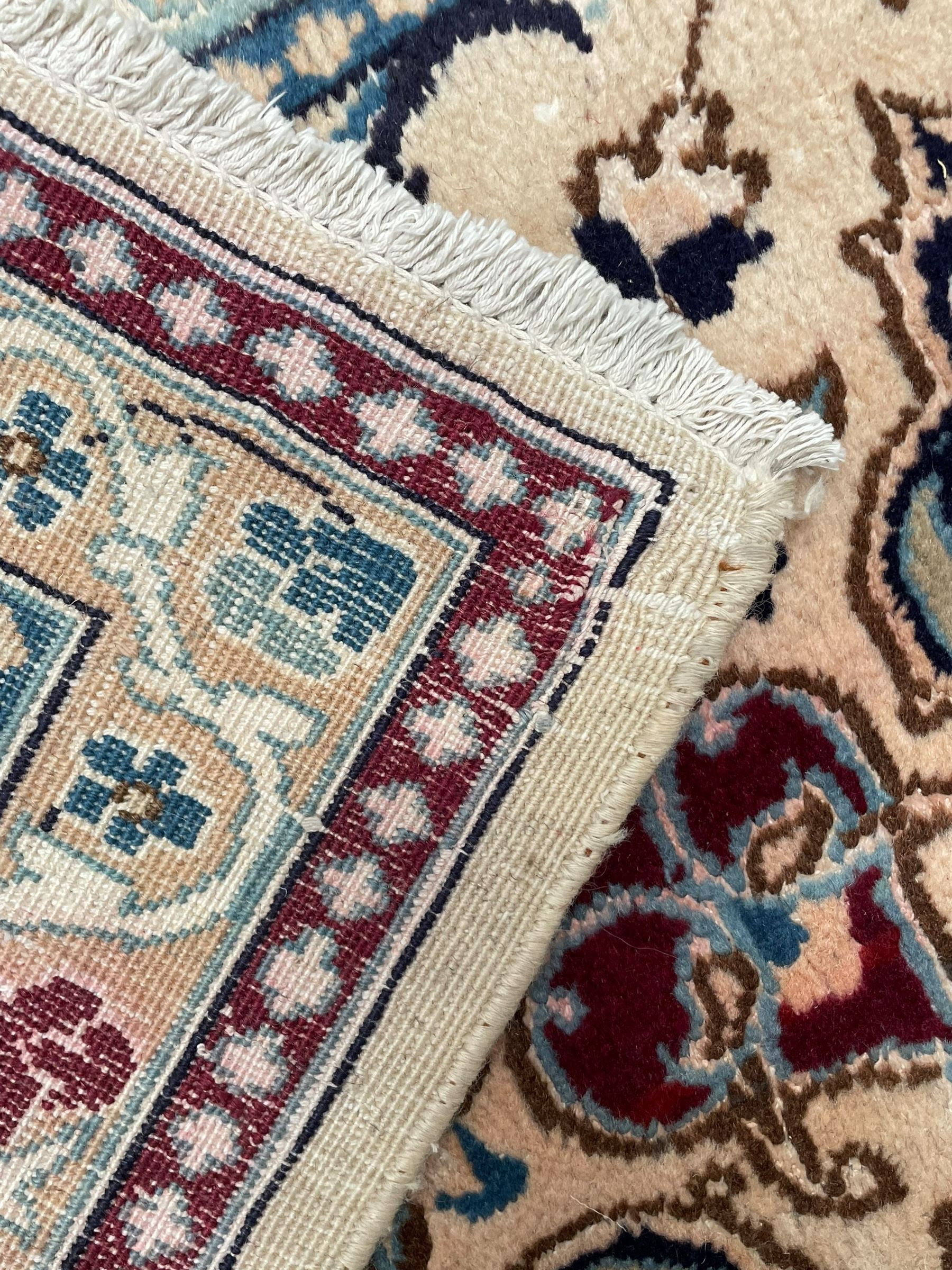 Persian Kashan olive ground carpet, central rosette medallion surrounded by swirling leafy branches and palmettes, the spandrels decorated with further palmettes and foliate motifs, scrolling border interspersed with stylised plant motifs, with in guard stripes