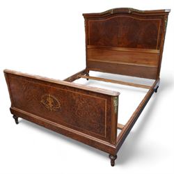 Louis XVI design walnut double bed frame, arched headboard decorated with gilt metal bell-flower swags, the amboyna panel with satinwood banding, flanked with chamfered uprights applied with gilt metal cartouche foliate mounts, the matching footboard with a central oval inlaid urn panel, raised on turned feet