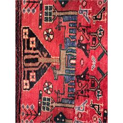 Persian crimson ground runner, the field decorated with stylised tree and animal motifs, indigo ground border decorated with alternating stylised flowerhead and bird motifs 