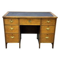 Edwardian oak twin pedestal desk, moulded rectangular top with inset writing surface, fitted with seven drawers, panelled sides, on stile supports 