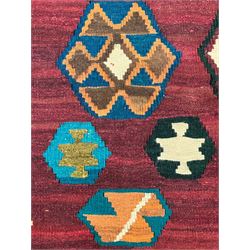 South West Persian Qashqai Kilim, crimson ground and decorated with three rows of geometric motifs, within zig-zag borders 