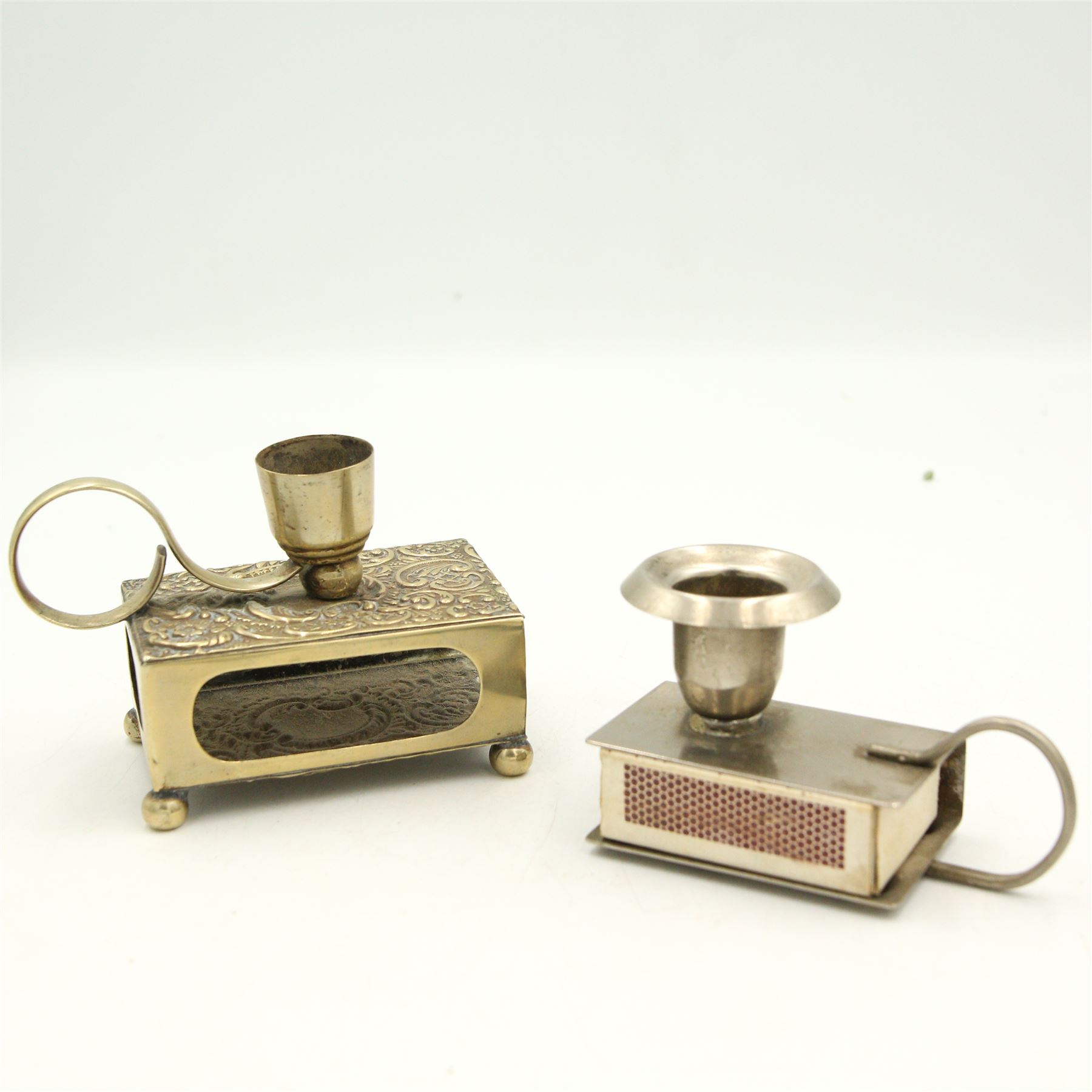 Three Victorian and later silver-plated combination matchbox holders/ candlesticks, a silver-plated combination matchbox holder and ashtray, an early 20th century papier mache wall pocket with striker and a leather matchbox holder in the form of a slipper (6)