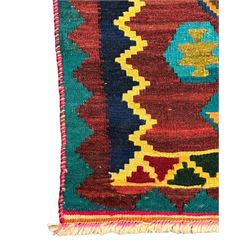 South West Persian Qashqai Kilim, crimson ground and decorated with three rows of geometric motifs, within zig-zag borders 