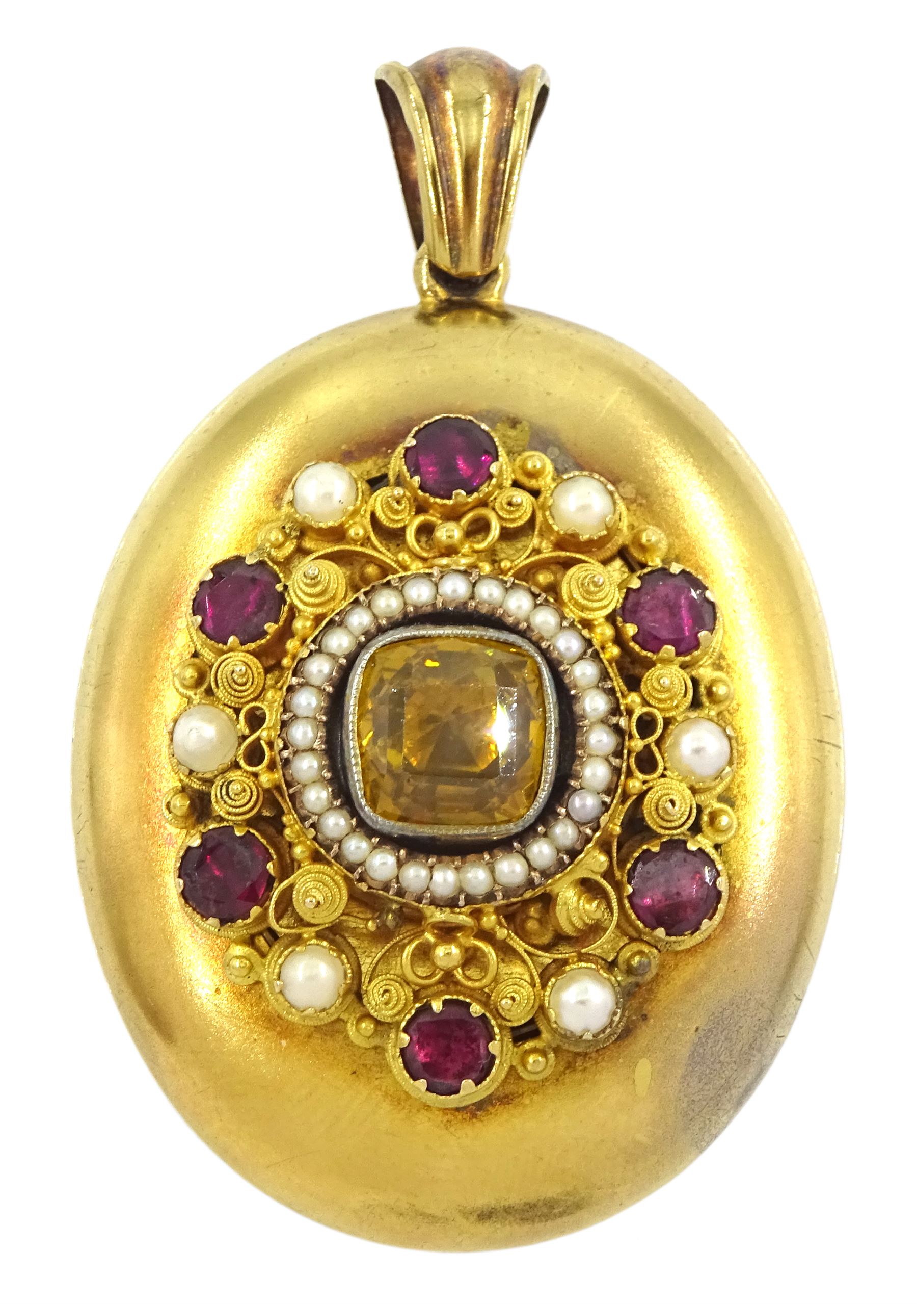 Victorian gold locket, the applied wirework decoration set with garnets, pearls and a paste yellow stone, with glazed reverse