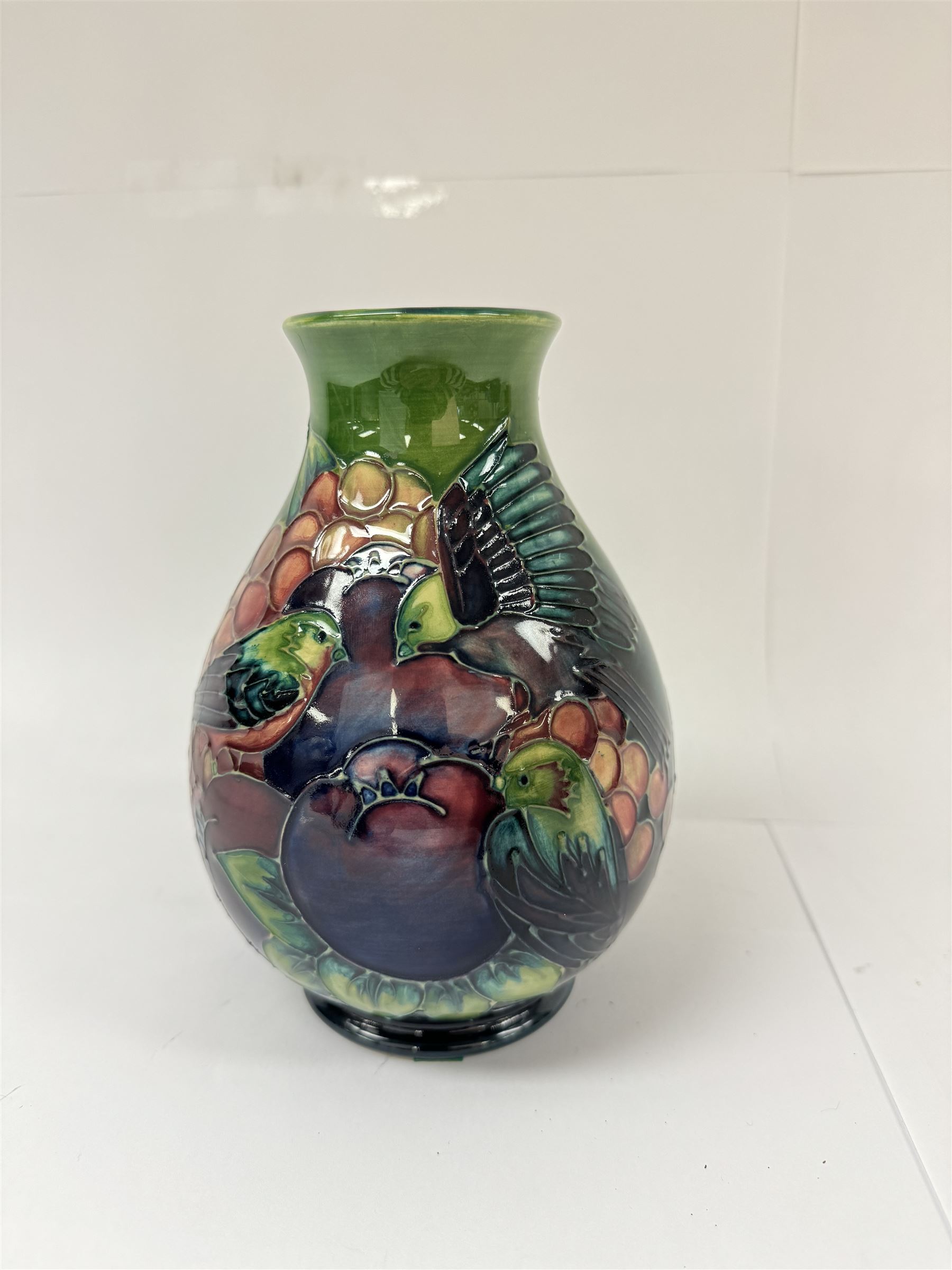 Moorcroft vase of baluster decorated in the Finches pattern with green ground, designed by Sally Tuffin, with makers mark beneath, H20cm