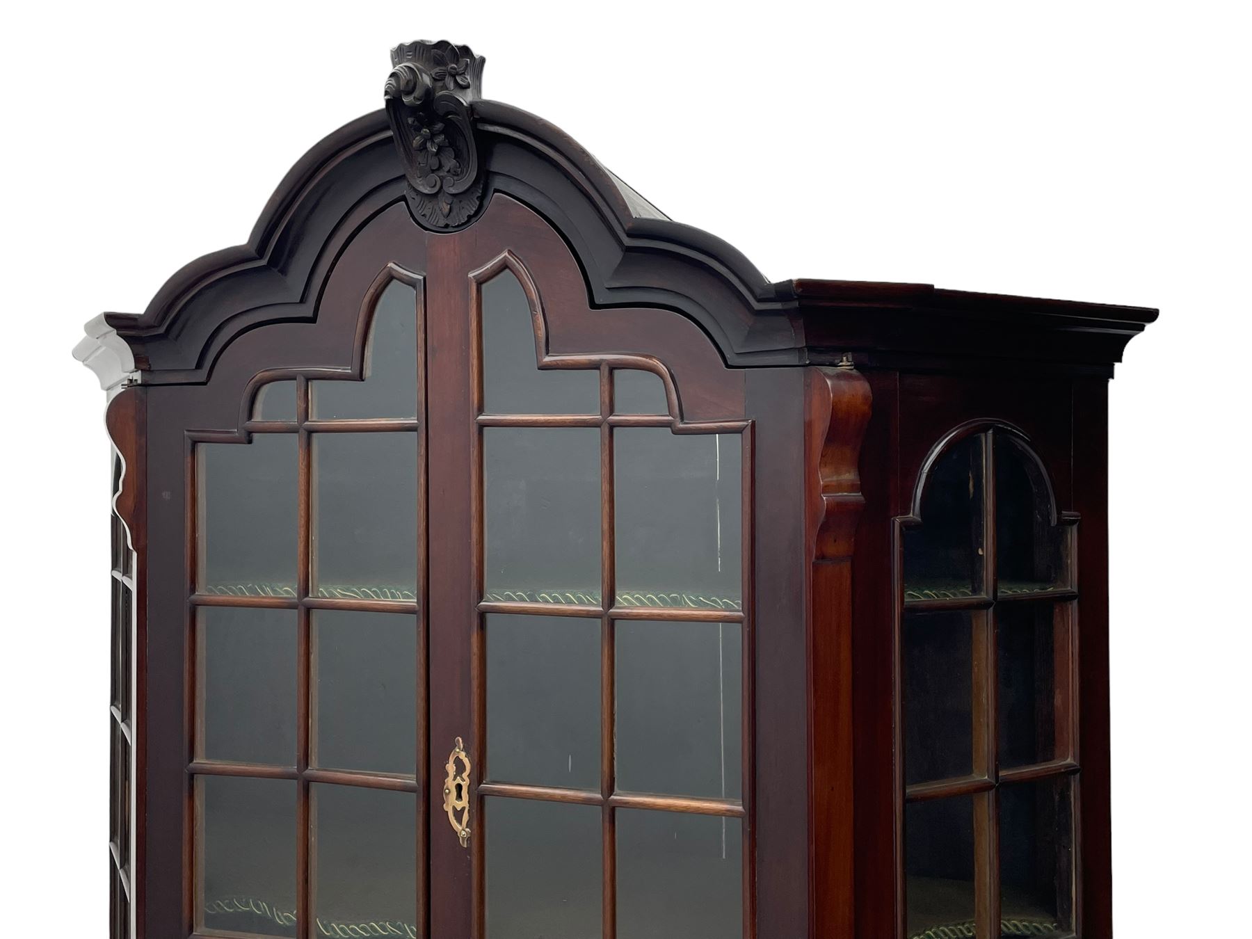 19th century Dutch mahogany vitrine on chest, shaped moulded pediment with central C-scroll and flowerhead carved mount, enclosed by two astragal glazed doors, the interior fitted with fabric lined shelves, four graduating long drawers below, on ball and claw carved feet 