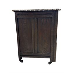 Victorian carved oak kneehole desk, the rectangular top with carved edge, above central drawer with carved front and brass handles, central kneehole with cupboard door, flanked by two banks of three graduating drawers each with similarly carved decoration, on shaped plinth base with castors