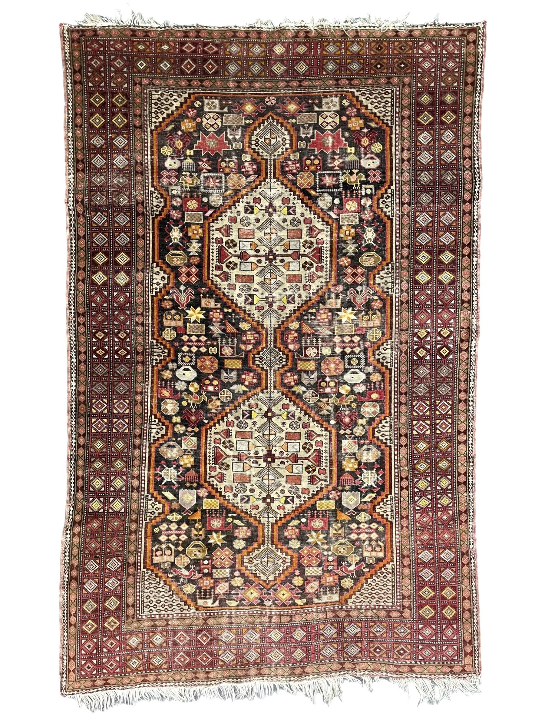 Persian Hamadan dark indigo ground rug, the field decorated with two connected pole medallions, decorated all over with small geometric and stylised bird motifs, geometric design border with repeating pattern 