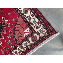Persian Hamandan rug, the red ground field decorated with triple medallions and stylised motifs