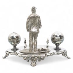 Victorian silver-plated inkstand by James Dixon & Sons, the quatrefoil base surmounted with a figure of a lawn bowler stood upon an oval grass base, with three lawn bowls by his feet, the inkwells formed as two bowls, each with hinged covers and silver-plated liners, bamboo moulded pen rest and gallery, supported by four pierced and splayed feet, L22cm x H17cm