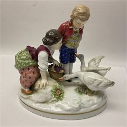 Two 19th century german figures, each modelled as children feeding birds, H19cm 