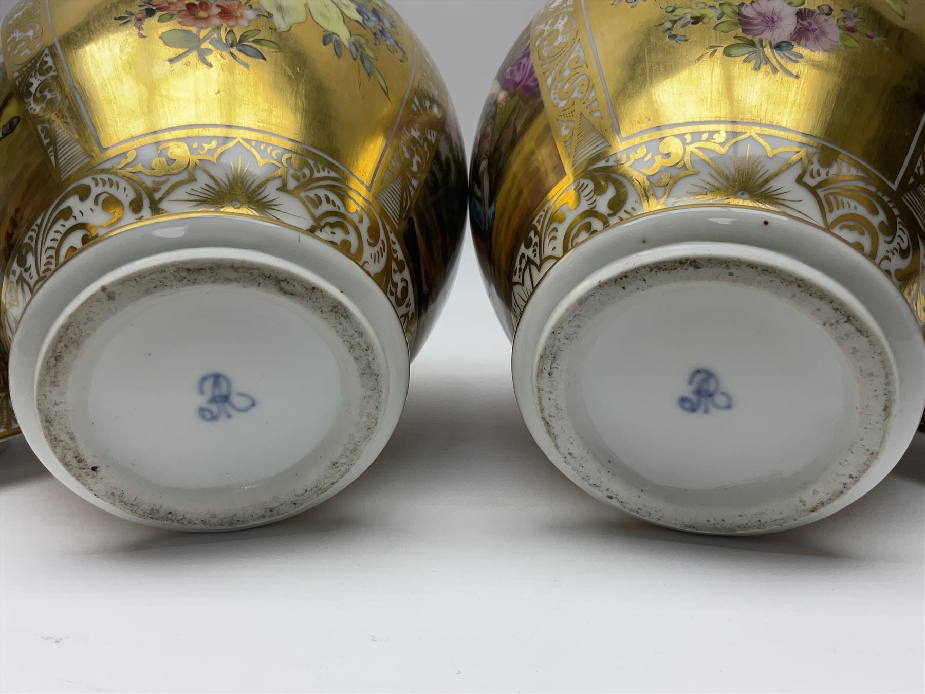 Pair of late 19th century Helena Wolfsohn vases and covers, each of baluster form with domed cover, painted with alternating panels of romantic scenes and floral sprays upon gilt ground, with Augustus Rex mark to base, H27cm