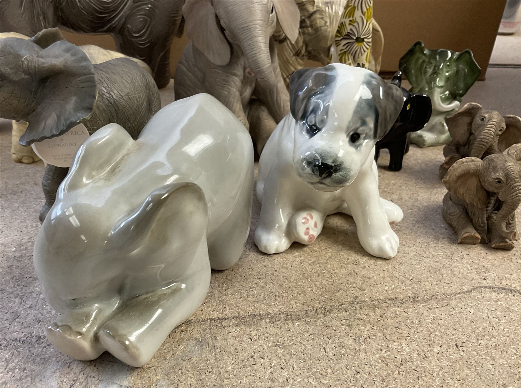 Group of ceramic and resin animal figures, mostly elephants, to include USSR model of a seated Terrier puppy, and a USSR model of a baby elephant, in one box