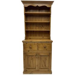 Solid pine dresser, fitted with plate rack above two drawers and two cupboards