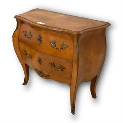 Late 20th century French design walnut bombe chest, shaped moulded top with quarter-matched veneers within crossbanding, fitted with two drawers with foliate cast metal handles and escutcheons, on tapering supports with ornate cast caps 