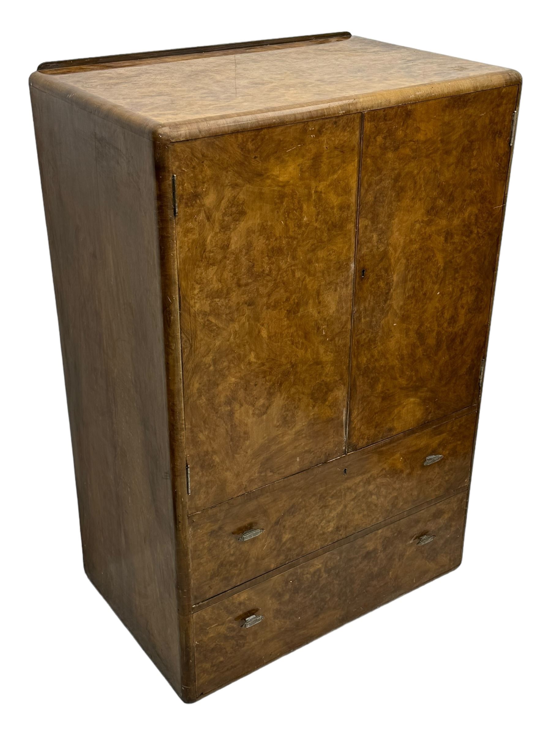 Early 20th century burr walnut cabinet, rectangular top with raised back, over double-door cupboard enclosing camphor interior with single shelf, lower section fitted with two drawers